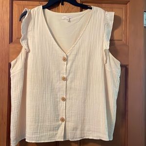 Dressy cap sleeved textured blouse with wooden buttons.